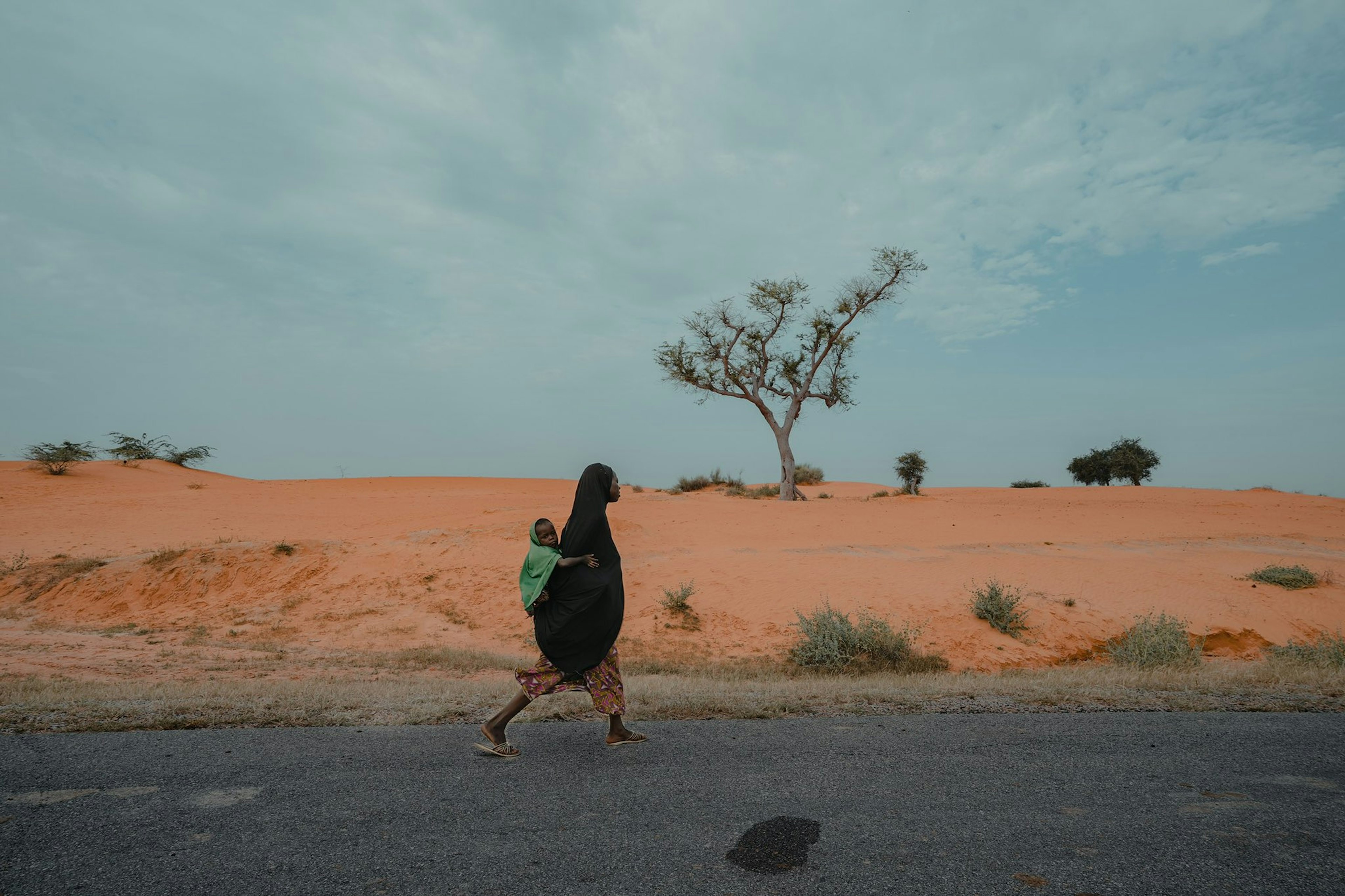 woman working with her child back